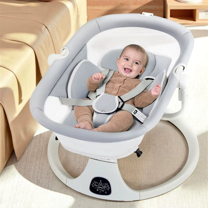 Baby in a white and gray baby swing with a beige couch in the background