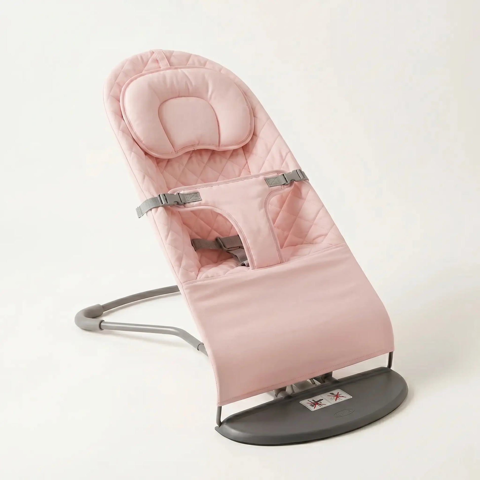Pink baby bouncer chair on a white background