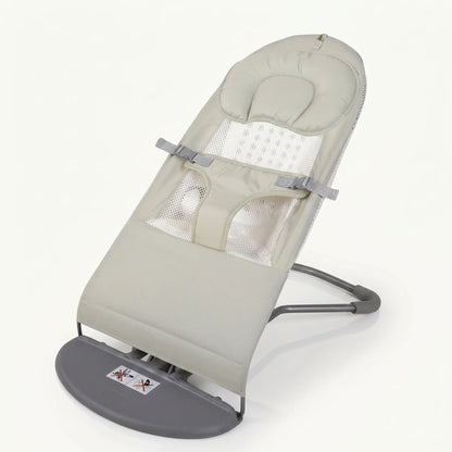 Baby bouncer with beige cushion and gray base on a white background