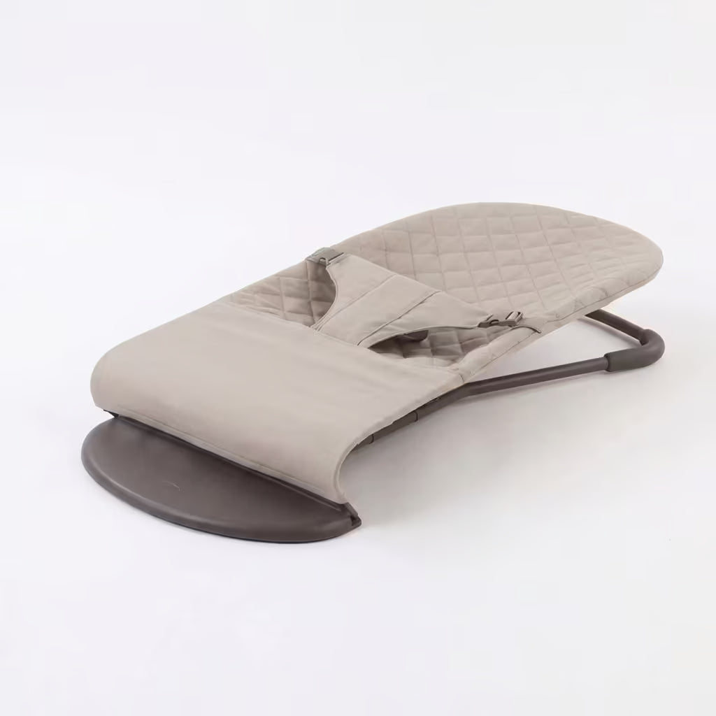 Baby bouncer with quilted design on a white background.