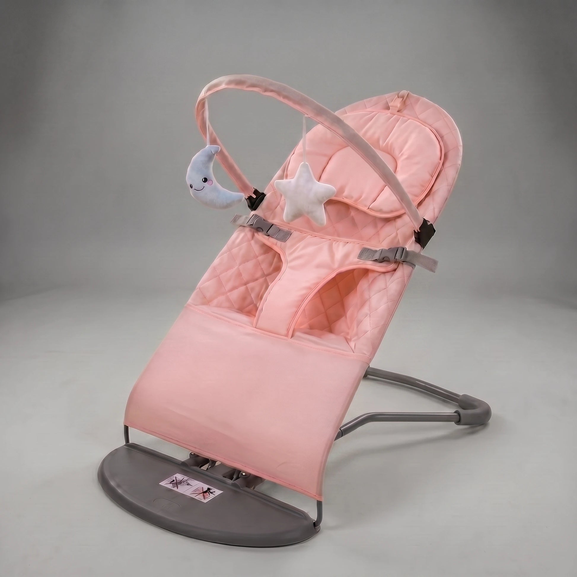 Pink baby bouncer with star and moon toys on a gray background