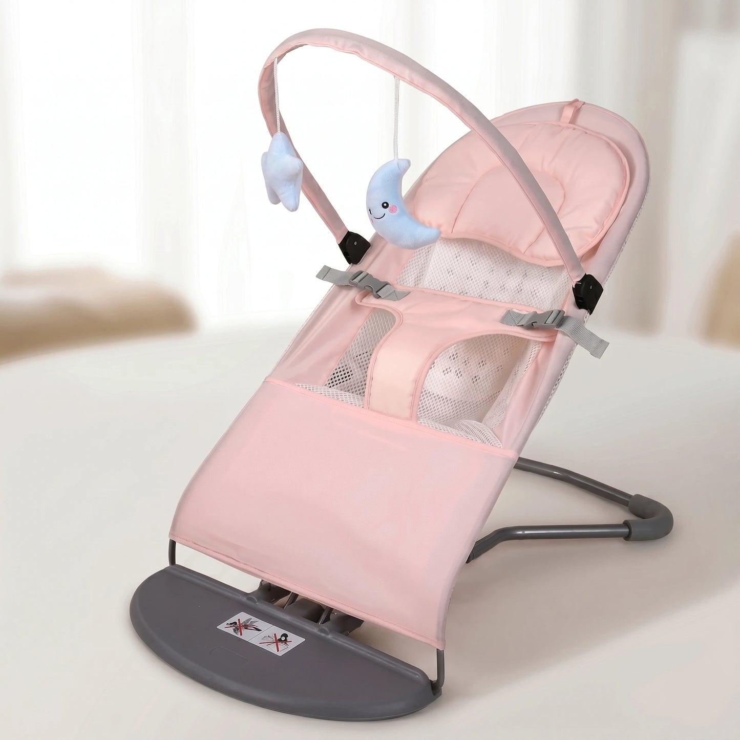 Pink baby swing with gray base on a light background